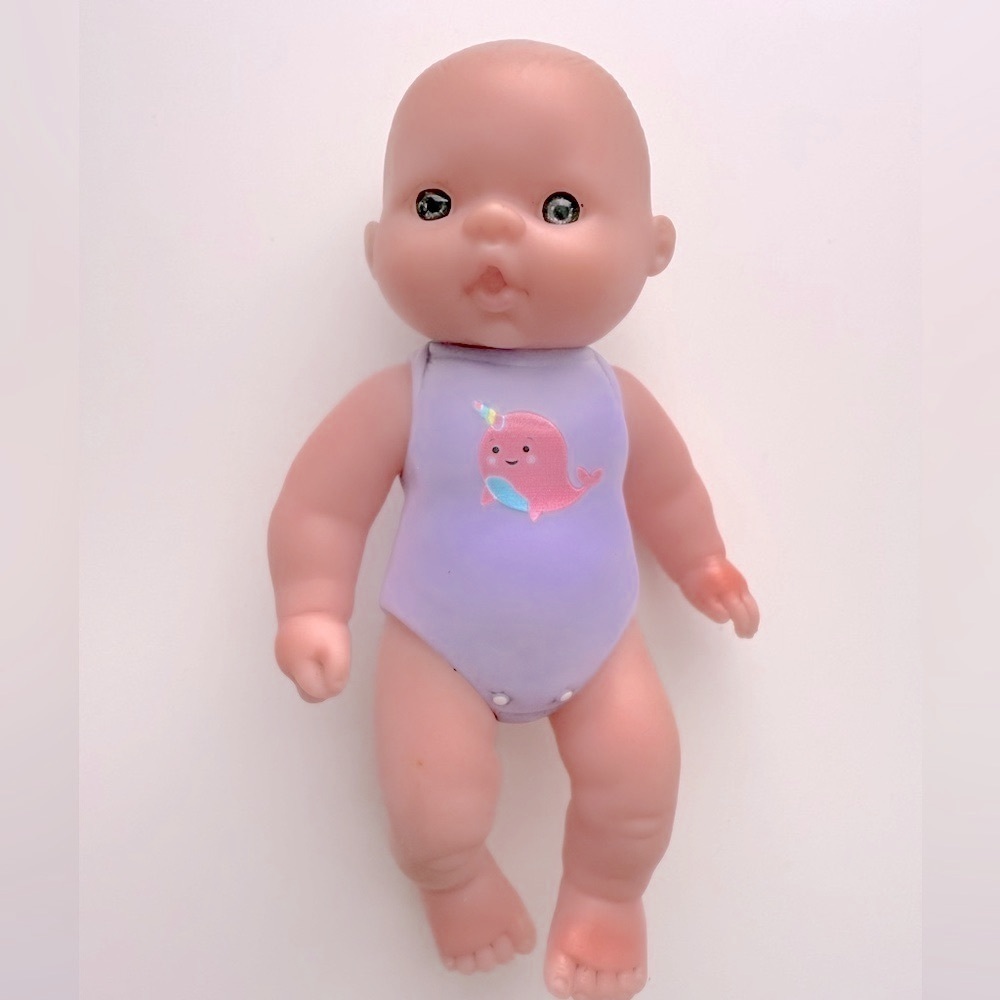 Mini Baby Doll Wearing A Narwhal Onesie